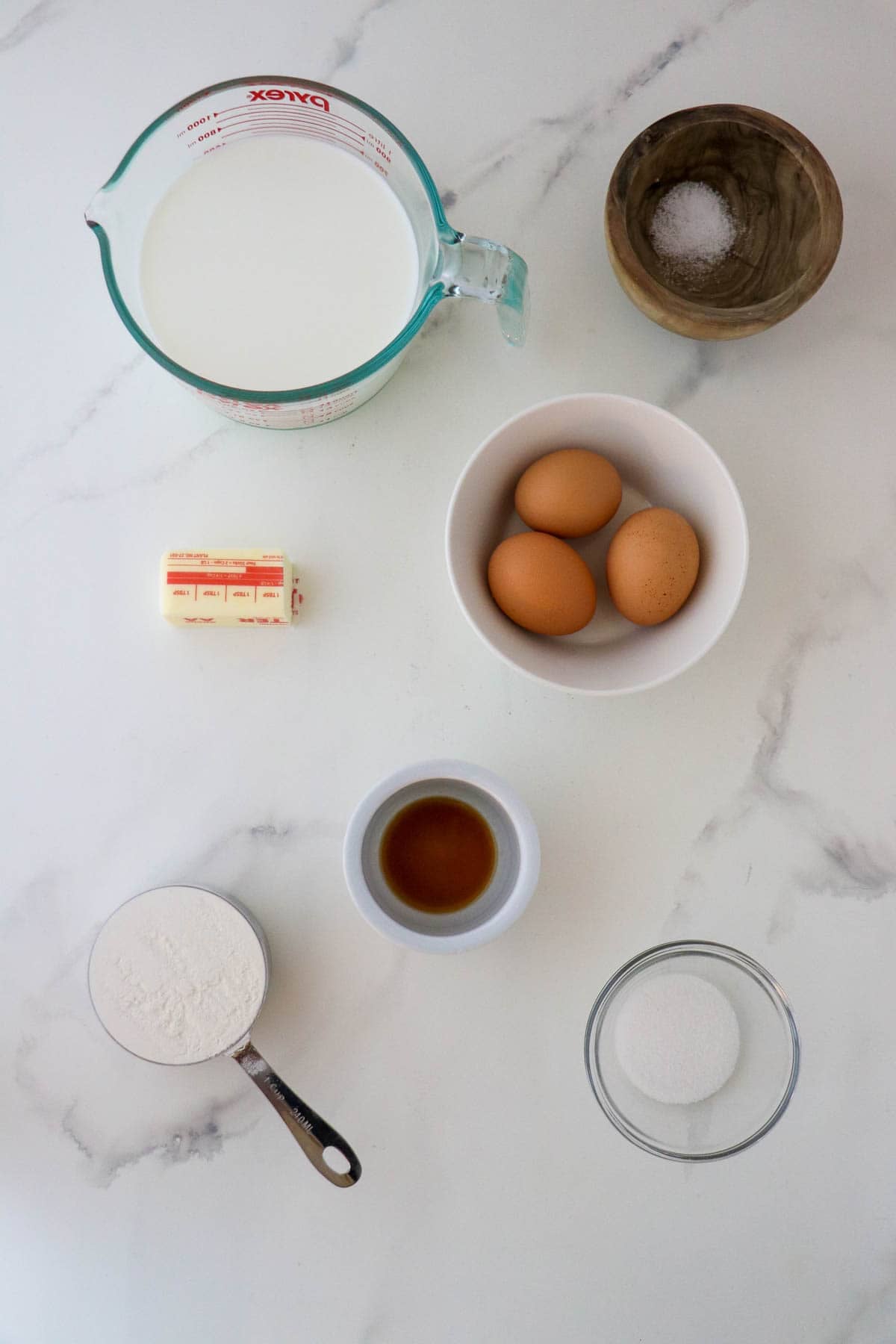 Ingredients needed for Swedish Oven Pancake (Ugnspannkaka): milk, eggs, butter, flour salt, sugar and vanilla extract.