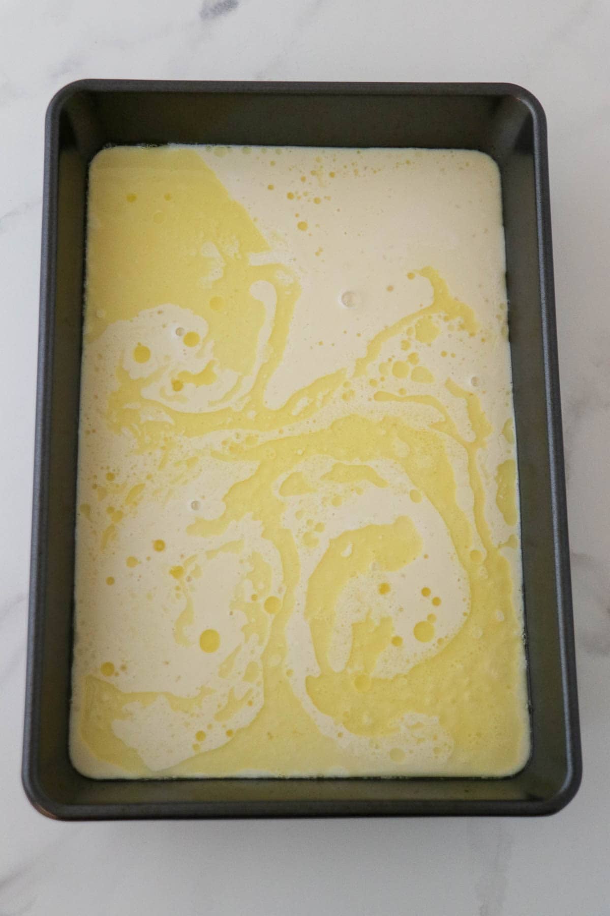 Swedish Oven Pancake (Ugnspannkaka) batter poured into a 9x13 pan.
