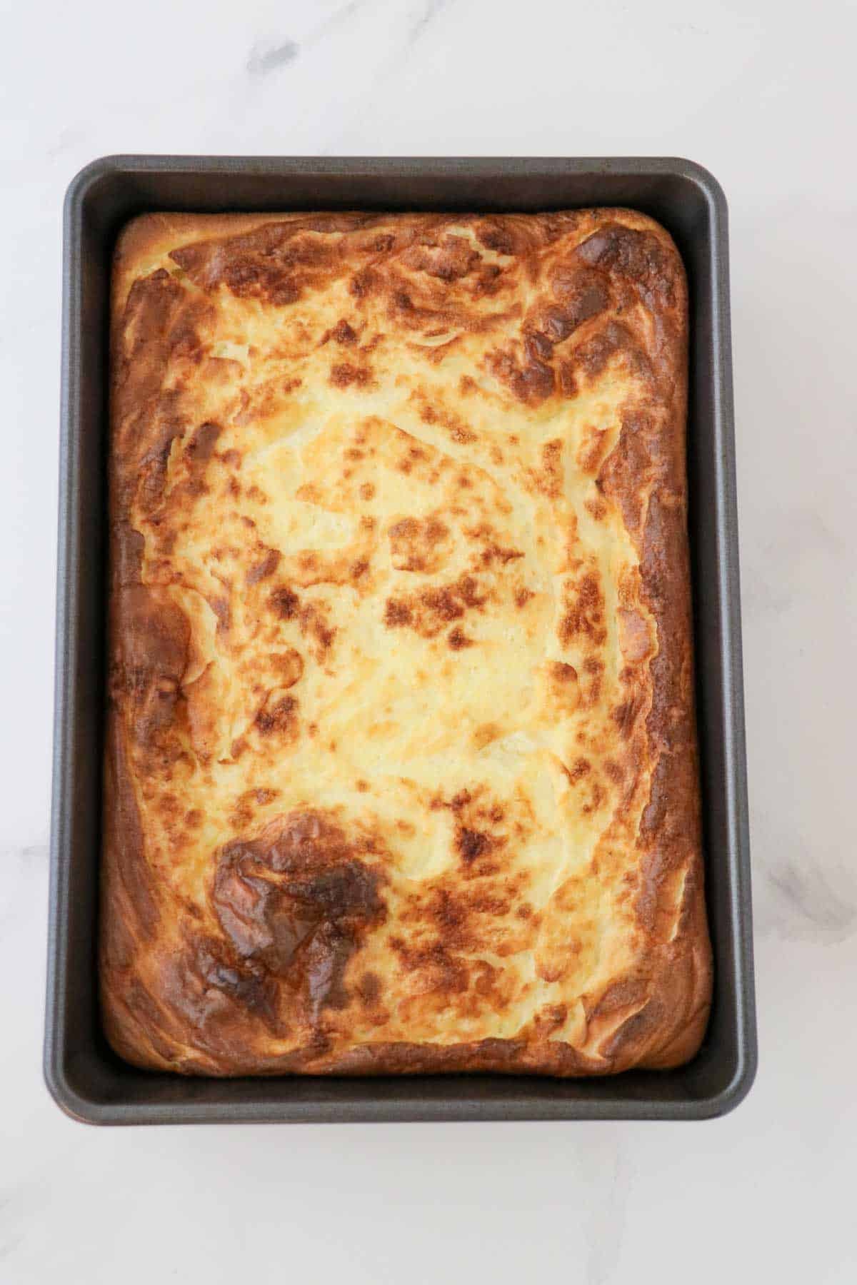 Swedish Oven Pancake (Ugnspannkaka) baked in a 9x13 pan.